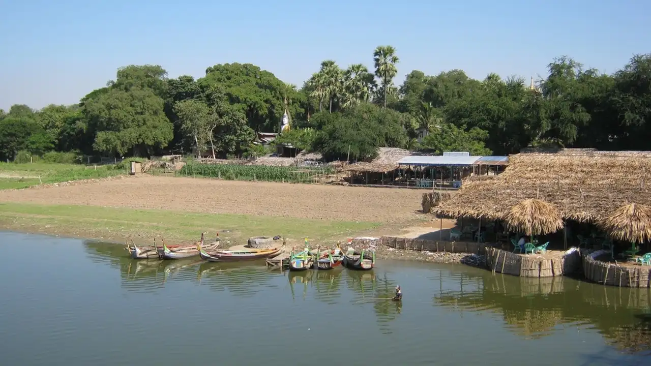Close up on a plate of mashed potatoes, topped with baked pork chops with cream of mushroom soup, and a side of green beans.