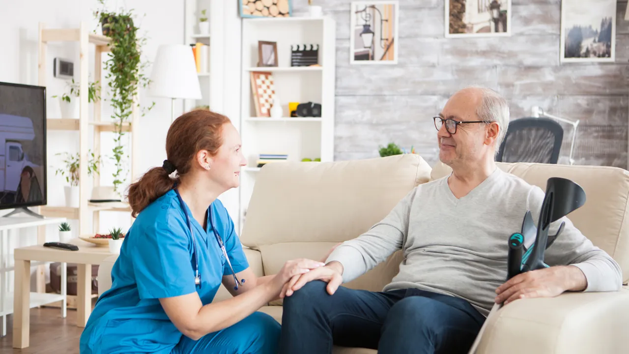 Close up on a plate of mashed potatoes, topped with baked pork chops with cream of mushroom soup, and a side of green beans.