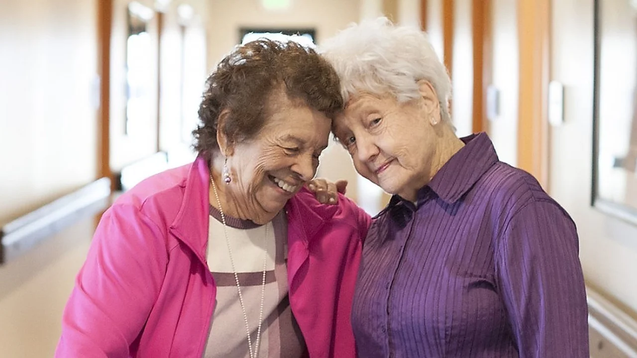 Close up on a plate of mashed potatoes, topped with baked pork chops with cream of mushroom soup, and a side of green beans.