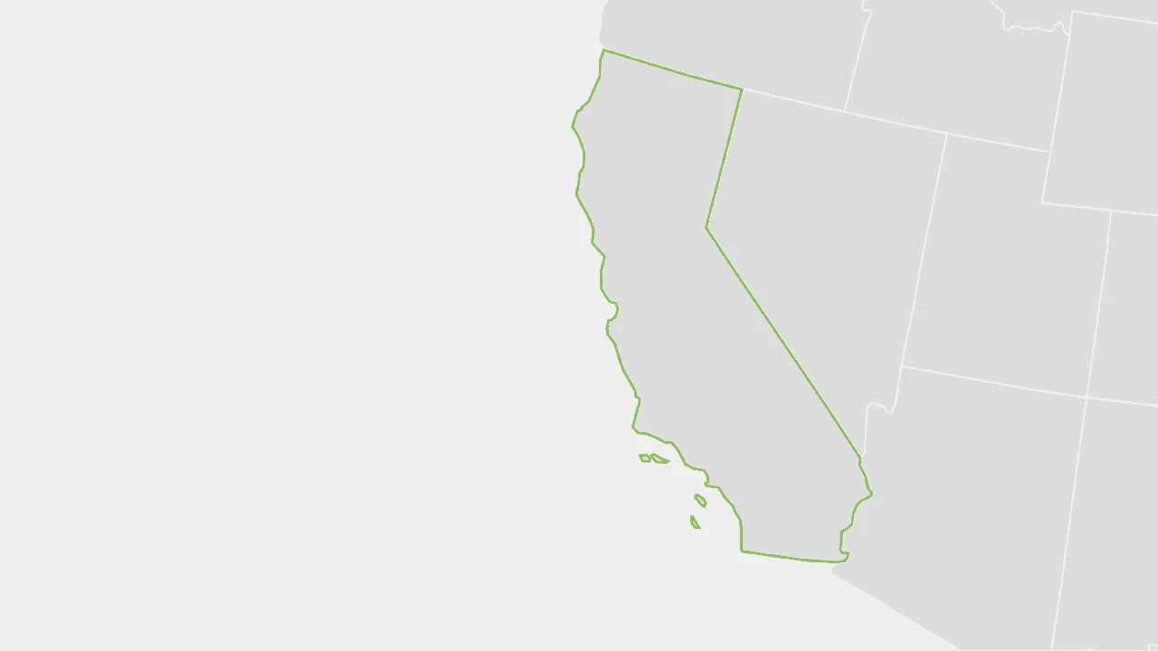 Close up on a plate of mashed potatoes, topped with baked pork chops with cream of mushroom soup, and a side of green beans.