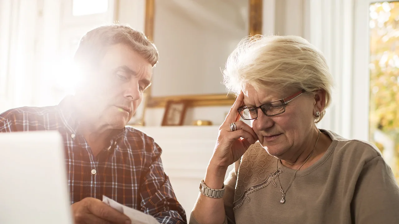 Two mint chocolate milkshakes with whipped cream and green sprinkles.