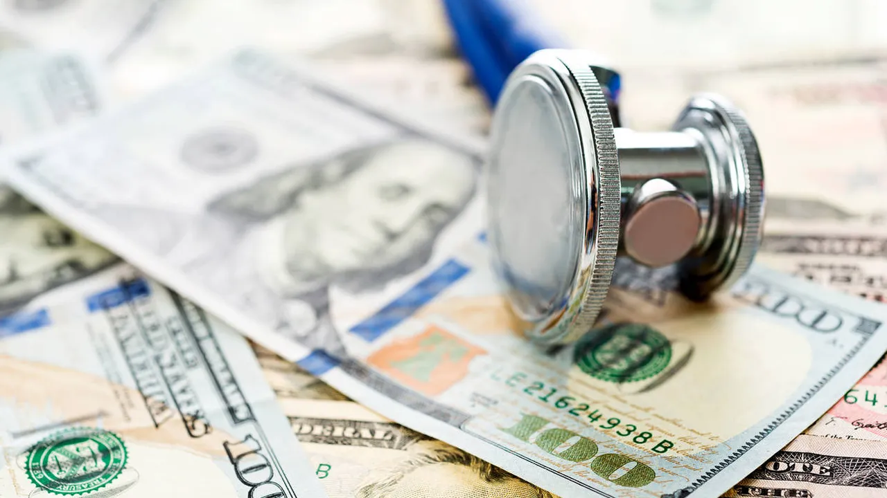 Close up on a plate of mashed potatoes, topped with baked pork chops with cream of mushroom soup, and a side of green beans.